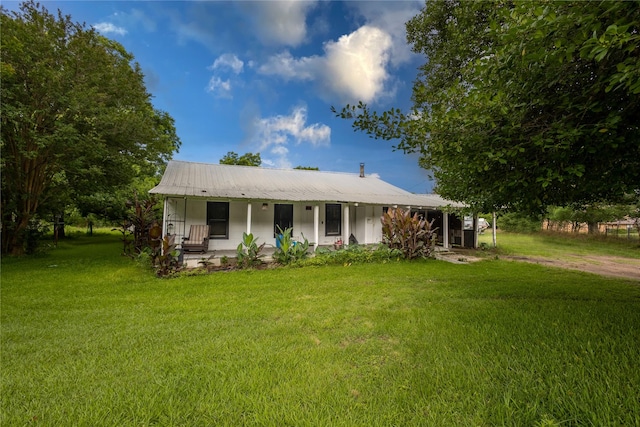 1357 W State Highway 154, Quitman, TX 75783 - view of front of house with covered porch, a front yard, and a metal roof