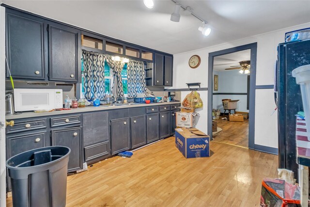 1357 W State Highway 154, Quitman, TX 75783 - kitchen with white microwave, light wood-style floors, ceiling fan, rail lighting, and light countertops