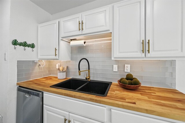 3105 Dupree St, Irving, TX 75062 - kitchen featuring butcher block counters, stainless steel dishwasher, tasteful backsplash, and white cabinetry
