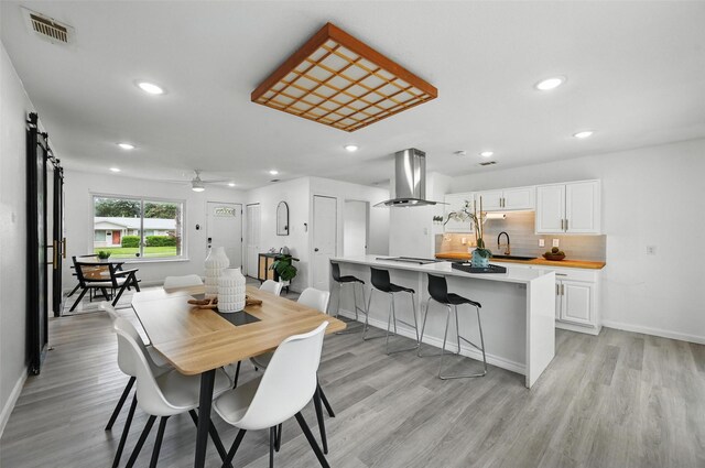 3105 Dupree St, Irving, TX 75062 - dining space with light wood-style floors, a ceiling fan, recessed lighting, and a barn door