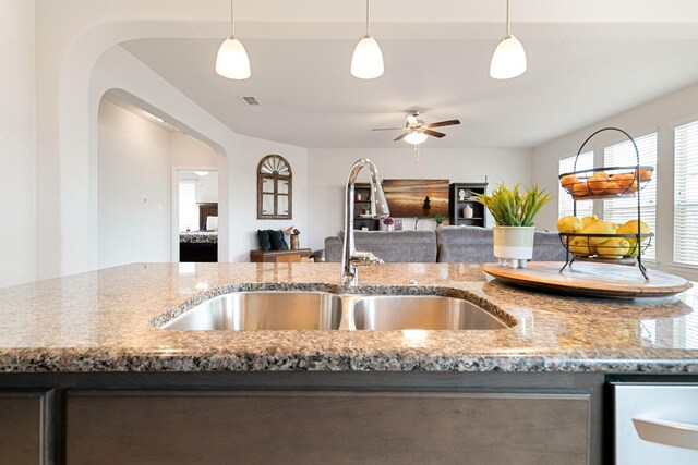 1112 Metaline Trl, Fort Worth, TX 76177 - kitchen featuring ceiling fan, arched walkways, stone counters, decorative light fixtures, and open floor plan