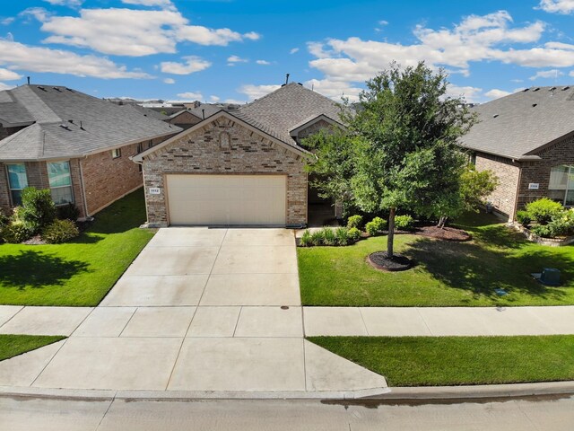 1112 Metaline Trl, Fort Worth, TX 76177 - view of front facade featuring a garage, concrete driveway, brick siding, and a front yard