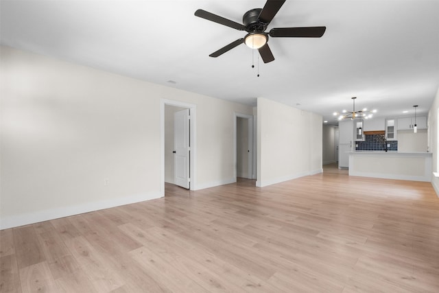 2117 Andrew Ave, Fort Worth, TX 76105 - unfurnished living room featuring a chandelier, ceiling fan, and light wood finished floors
