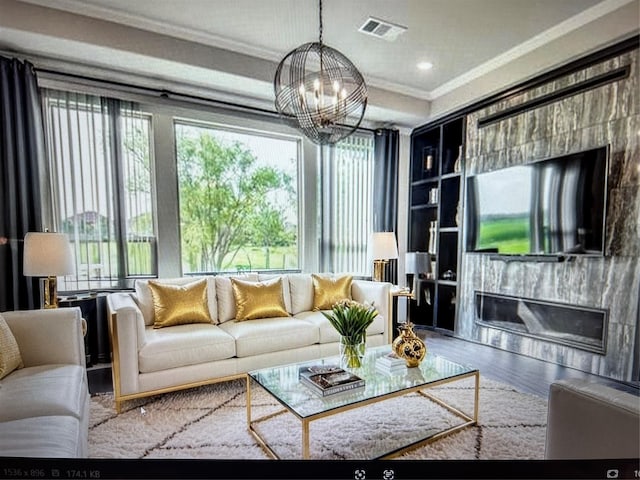 8509 Cocobolo Dr, Denton, TX 76207 - living room featuring crown molding, a chandelier, wood finished floors, recessed lighting, and a fireplace