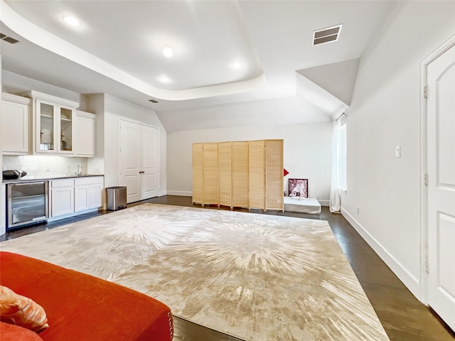1500 Whistle Brook Dr, Allen, TX 75013 - unfurnished bedroom with beverage cooler, recessed lighting, bar with sink, a raised ceiling, and dark wood-style flooring