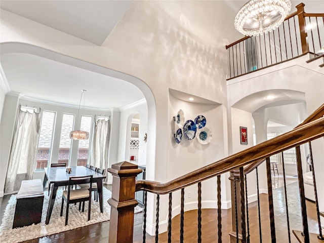 1500 Whistle Brook Dr, Allen, TX 75013 - stairs featuring a chandelier, ornamental molding, wood finished floors, and arched walkways