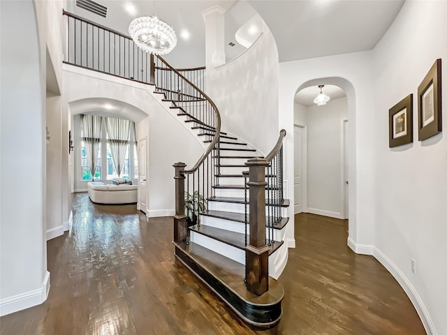 1500 Whistle Brook Dr, Allen, TX 75013 - entrance foyer with arched walkways, stairs, wood finished floors, a chandelier, and a towering ceiling