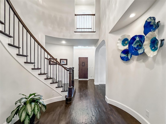 1500 Whistle Brook Dr, Allen, TX 75013 - foyer featuring arched walkways, wood finished floors, a high ceiling, and stairway