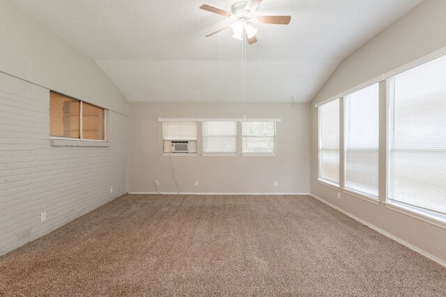 5905 Wheaton Dr, Fort Worth, TX 76133 - carpeted spare room featuring vaulted ceiling, a ceiling fan, brick wall, and cooling unit