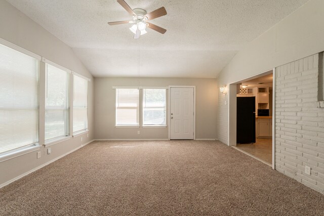 5905 Wheaton Dr, Fort Worth, TX 76133 - empty room featuring vaulted ceiling, light colored carpet, a ceiling fan, and a textured ceiling