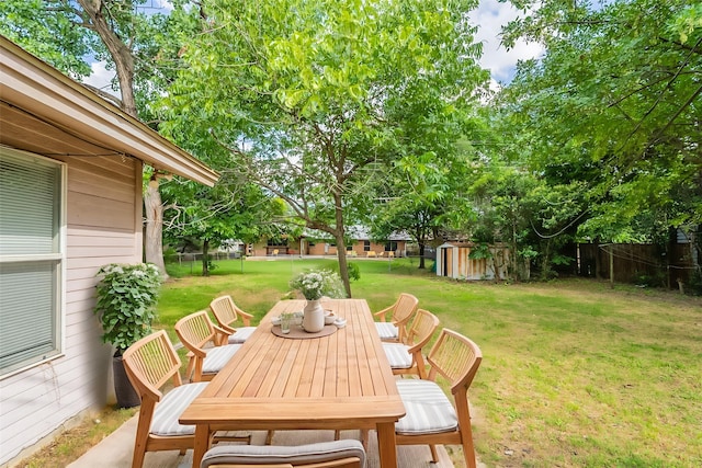 5905 Wheaton Dr, Fort Worth, TX 76133 - fenced yard featuring a storage unit and outdoor dining space