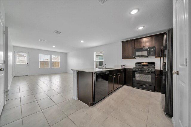 3165 Crestone Dr, Crandall, TX 75114 - kitchen with black appliances, open floor plan, plenty of natural light, dark brown cabinets, and recessed lighting