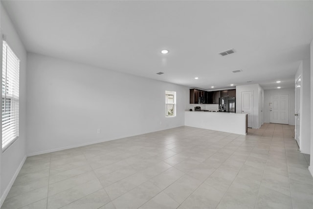 3165 Crestone Dr, Crandall, TX 75114 - unfurnished living room featuring recessed lighting, plenty of natural light, and light tile patterned floors