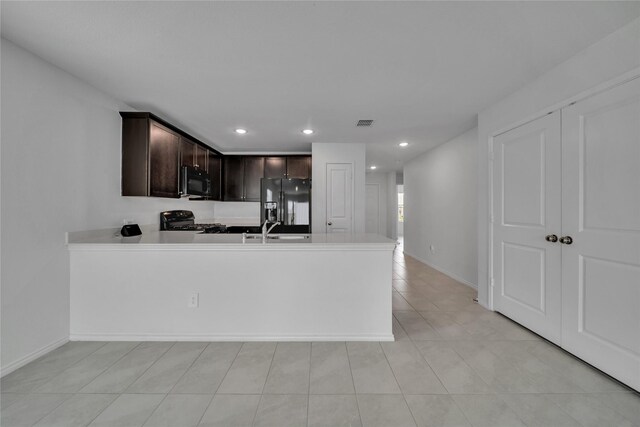 3165 Crestone Dr, Crandall, TX 75114 - kitchen with black appliances, dark brown cabinetry, a peninsula, light countertops, and recessed lighting