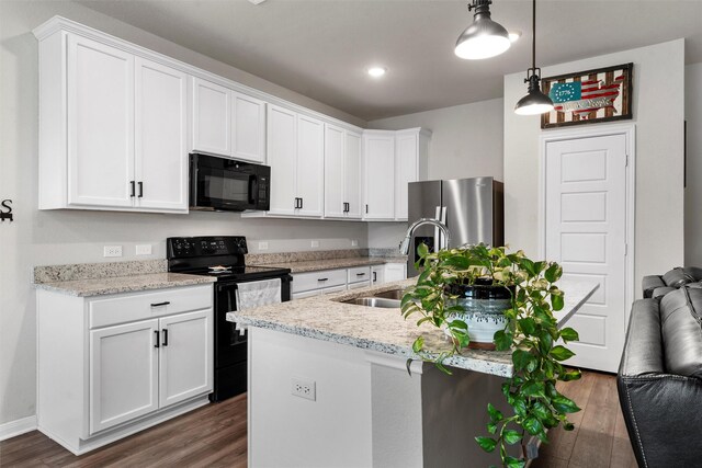 6932 Sulphur Ct, China Spring, TX 76633 - kitchen featuring black appliances, dark wood-type flooring, white cabinets, pendant lighting, and a center island with sink