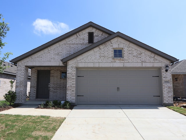14142 Maida Dr, Pilot Point, TX 76258 - view of front of home featuring concrete driveway, a garage, and brick siding
