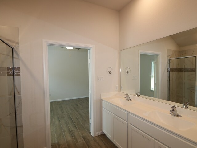 14142 Maida Dr, Pilot Point, TX 76258 - bathroom with wood finished floors, double vanity, and a stall shower