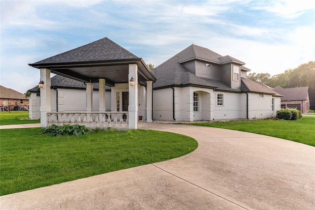 1016 Santiago Trl, Wylie, TX 75098 - rear view of house with roof with shingles, covered porch, a yard, and curved driveway