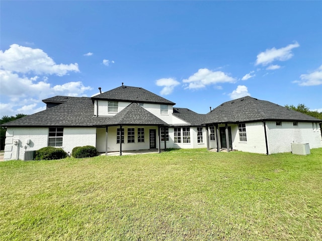 1016 Santiago Trl, Wylie, TX 75098 - back of house with a lawn, a shingled roof, and a patio area