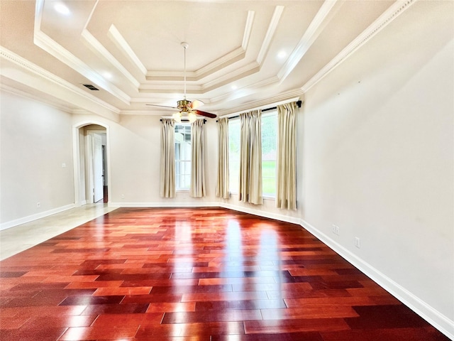 1016 Santiago Trl, Wylie, TX 75098 - spare room featuring a raised ceiling, wood-type flooring, arched walkways, a ceiling fan, and ornamental molding