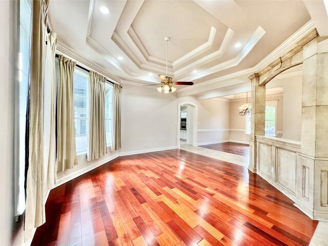 1016 Santiago Trl, Wylie, TX 75098 - unfurnished room with arched walkways, crown molding, wood finished floors, a tray ceiling, and a ceiling fan