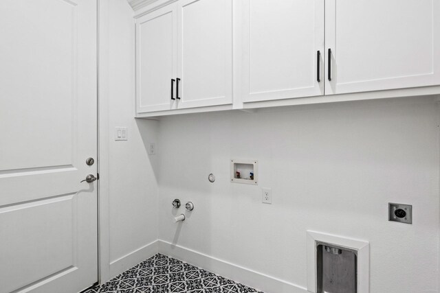 255 Kathryns Ct, Mount Pleasant, TX 75455 - washroom featuring washer hookup, hookup for an electric dryer, gas dryer hookup, cabinet space, and tile patterned floors