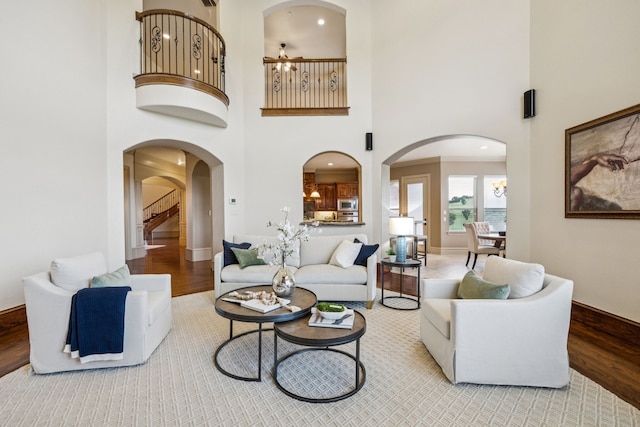 211 Tanner Creek Cir, Sunnyvale, TX 75182 - living area with arched walkways, wood finished floors, a high ceiling, stairway, and recessed lighting
