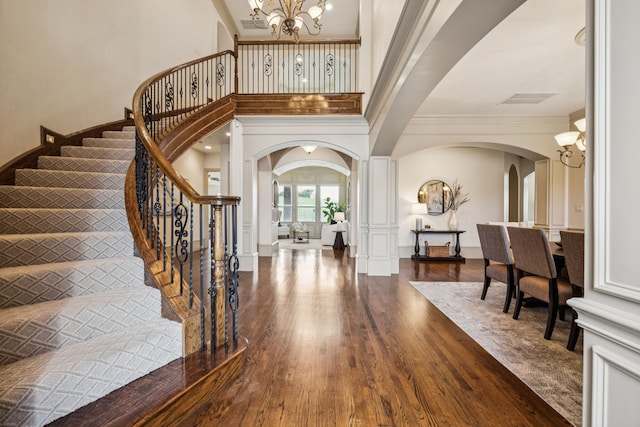 211 Tanner Creek Cir, Sunnyvale, TX 75182 - foyer entrance with arched walkways, a chandelier, dark wood-style flooring, crown molding, and stairway