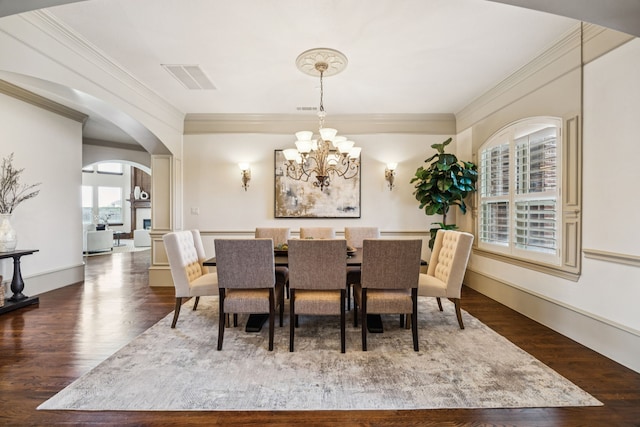 211 Tanner Creek Cir, Sunnyvale, TX 75182 - dining room featuring wood finished floors, arched walkways, crown molding, and a chandelier