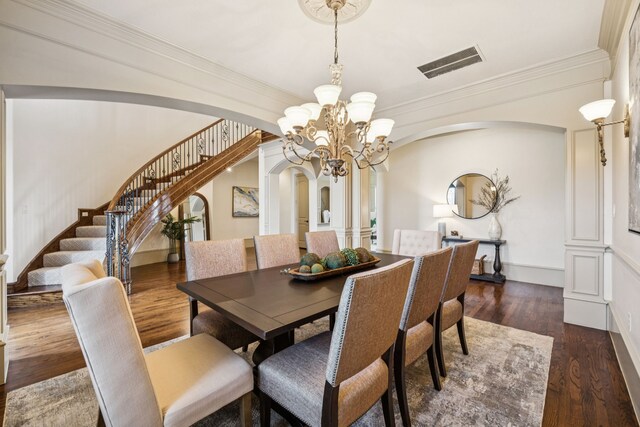 211 Tanner Creek Cir, Sunnyvale, TX 75182 - dining room with arched walkways, stairway, a chandelier, crown molding, and wood finished floors