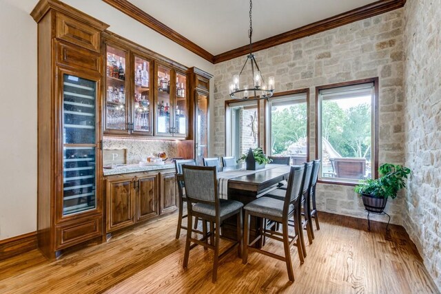 217 The Falls Dr, Sunnyvale, TX 75182 - dining space featuring a chandelier, crown molding, and light wood-style floors