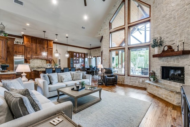 217 The Falls Dr, Sunnyvale, TX 75182 - living room featuring high vaulted ceiling, hardwood / wood-style flooring, recessed lighting, a fireplace, and ornamental molding