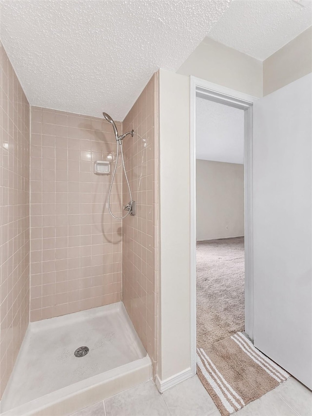 631 Sharp St, Mansfield, TX 76063 - full bathroom featuring tiled shower, a textured ceiling, and tile patterned flooring