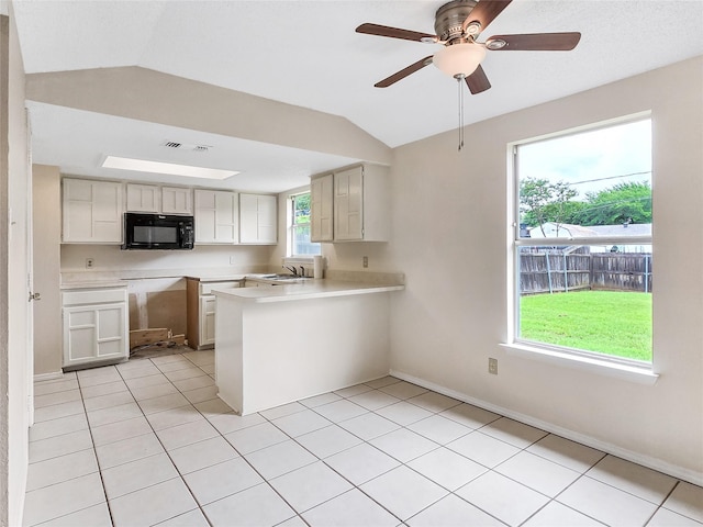 631 Sharp St, Mansfield, TX 76063 - kitchen featuring black microwave, a peninsula, lofted ceiling, light countertops, and a ceiling fan