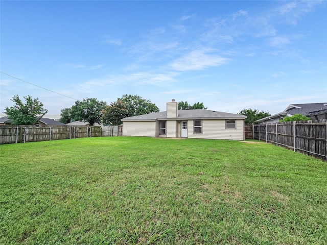 631 Sharp St, Mansfield, TX 76063 - back of house featuring a fenced backyard and a chimney