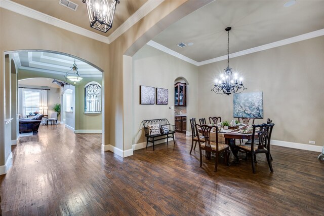 917 Stone Cottage Ln, Mckinney, TX 75069 - dining room with arched walkways, a chandelier, ornamental molding, and dark wood-style floors