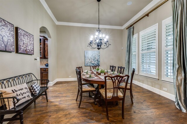 917 Stone Cottage Ln, Mckinney, TX 75069 - dining space with arched walkways, a chandelier, crown molding, and dark wood-style flooring