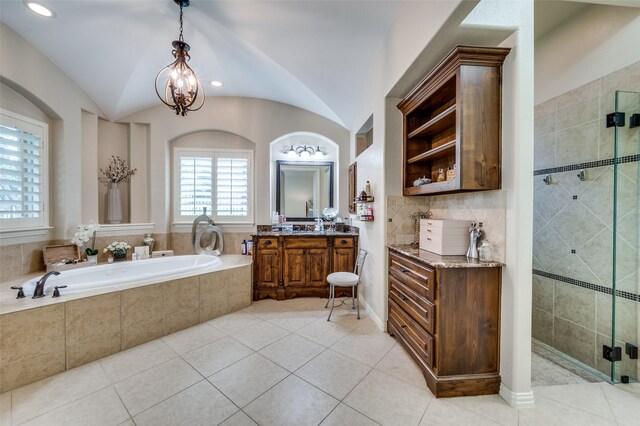 917 Stone Cottage Ln, Mckinney, TX 75069 - bathroom with a garden tub, vanity, a shower stall, tile patterned floors, and lofted ceiling
