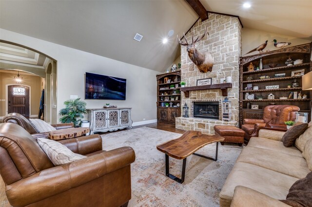 917 Stone Cottage Ln, Mckinney, TX 75069 - living room with arched walkways, wood finished floors, a stone fireplace, and recessed lighting