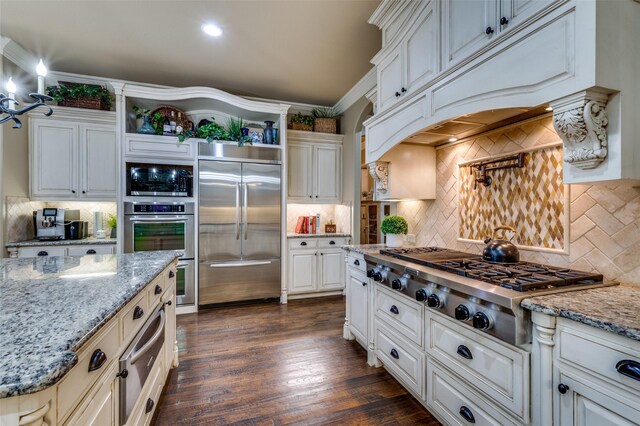 917 Stone Cottage Ln, Mckinney, TX 75069 - kitchen featuring built in appliances, backsplash, a warming drawer, open shelves, and custom range hood