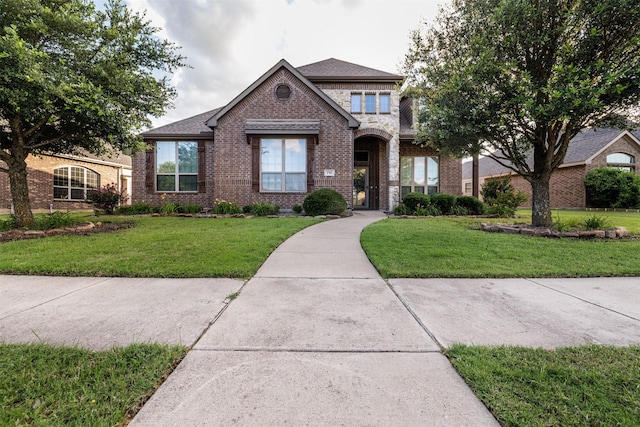 1701 Fair Oaks Ln, Royse City, TX 75189 - view of front of property featuring brick siding, a front lawn, and roof with shingles