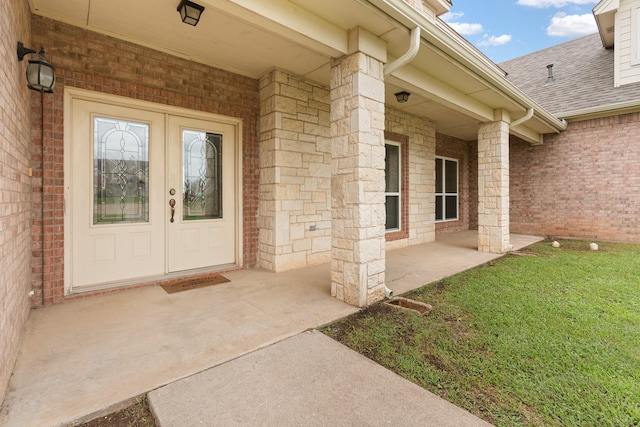 2008 Natchez Ct, Cleburne, TX 76033 - doorway to property featuring a shingled roof, brick siding, and a yard