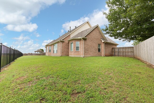 2008 Natchez Ct, Cleburne, TX 76033 - back of property featuring brick siding and a fenced backyard