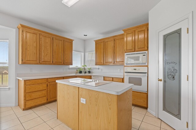 2008 Natchez Ct, Cleburne, TX 76033 - kitchen featuring white appliances, light tile patterned floors, light countertops, and a kitchen island