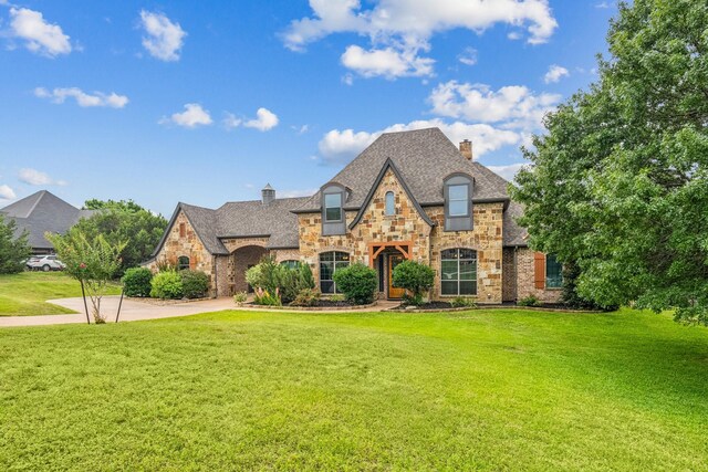 10133 Leaping Buck Pt, Fort Worth, TX 76126 - french country home with stone siding, a chimney, and a front lawn