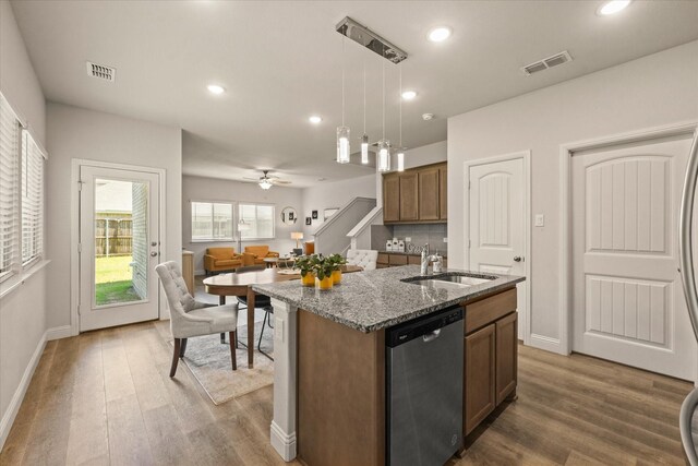 3109 Ethan Ln, Wylie, TX 75098 - kitchen featuring dishwasher, wood finished floors, stone countertops, an island with sink, and recessed lighting