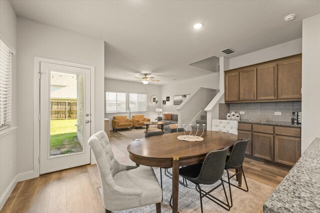 3109 Ethan Ln, Wylie, TX 75098 - dining area with light wood-style flooring, stairway, ceiling fan, and recessed lighting
