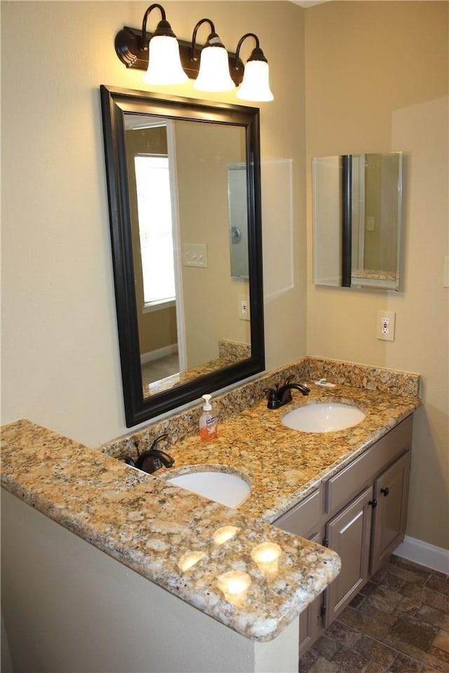 2501 Windchase Dr, Flower Mound, TX 75028 - bathroom featuring double vanity and stone finish floors