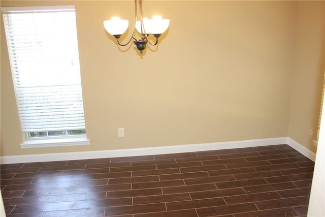 2501 Windchase Dr, Flower Mound, TX 75028 - spare room featuring a chandelier and dark wood-type flooring