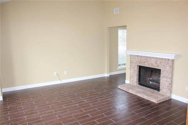 2501 Windchase Dr, Flower Mound, TX 75028 - unfurnished living room featuring wood finish floors, a fireplace, and a high ceiling